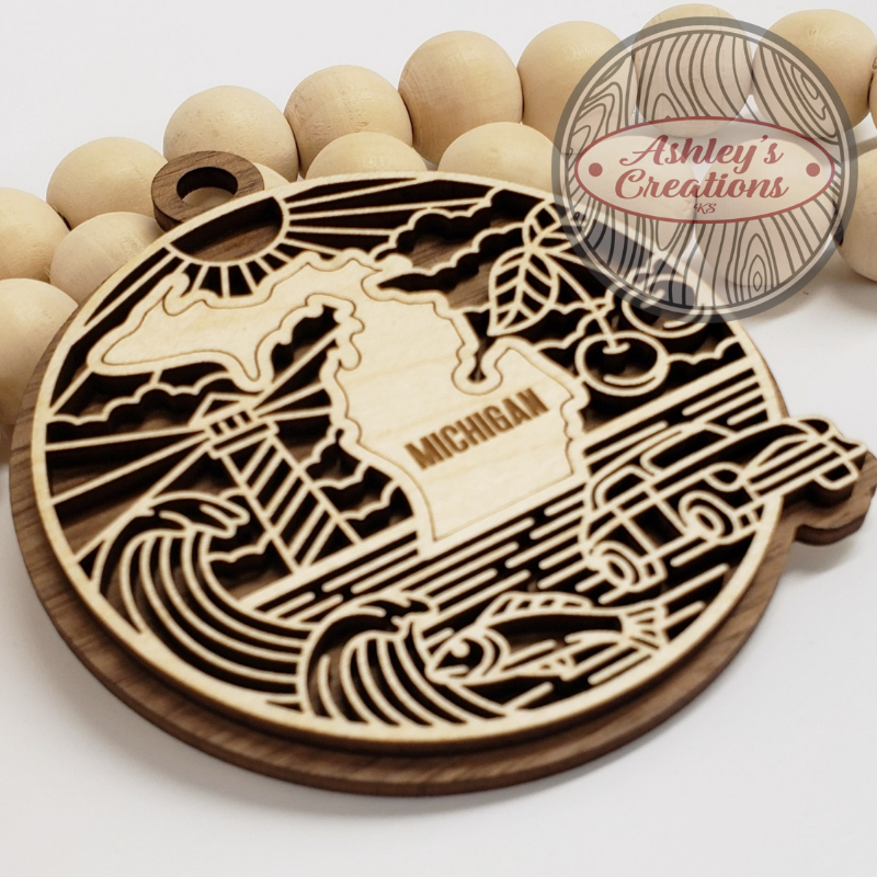 Wooden ornament with the state of Michigan in the middle.
