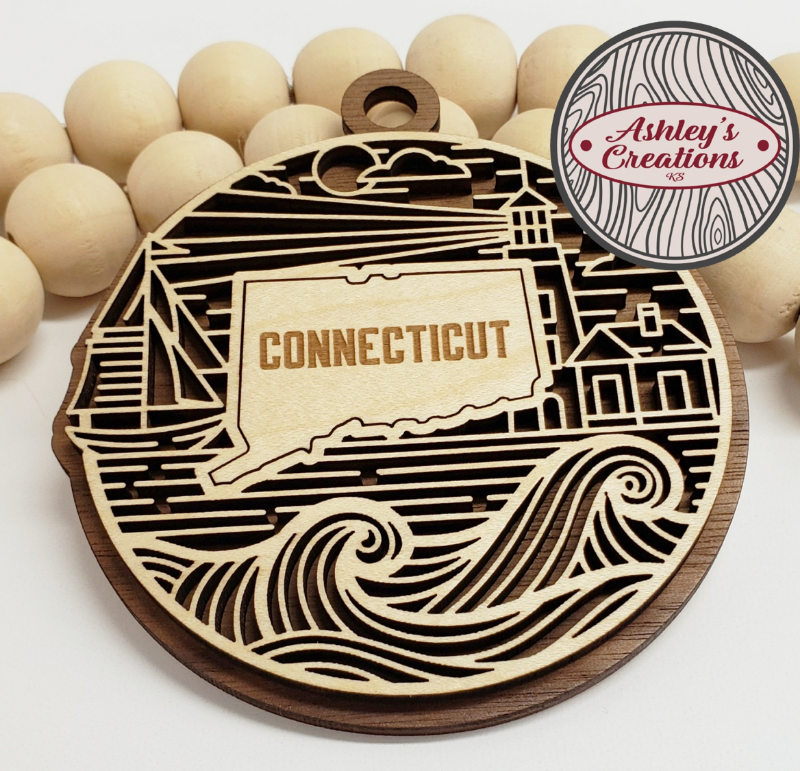 Wooden ornament with 'Connecticut' engraving on a white background