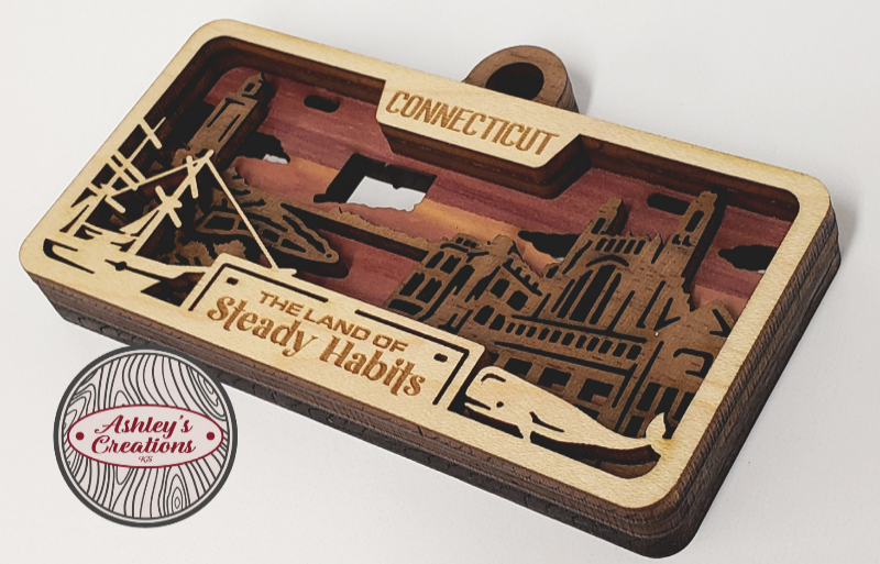 Wooden three layer license plate ornament with laser-cut designs and text, featuring 'Connecticut' and 'The Land of Steady Habits'.