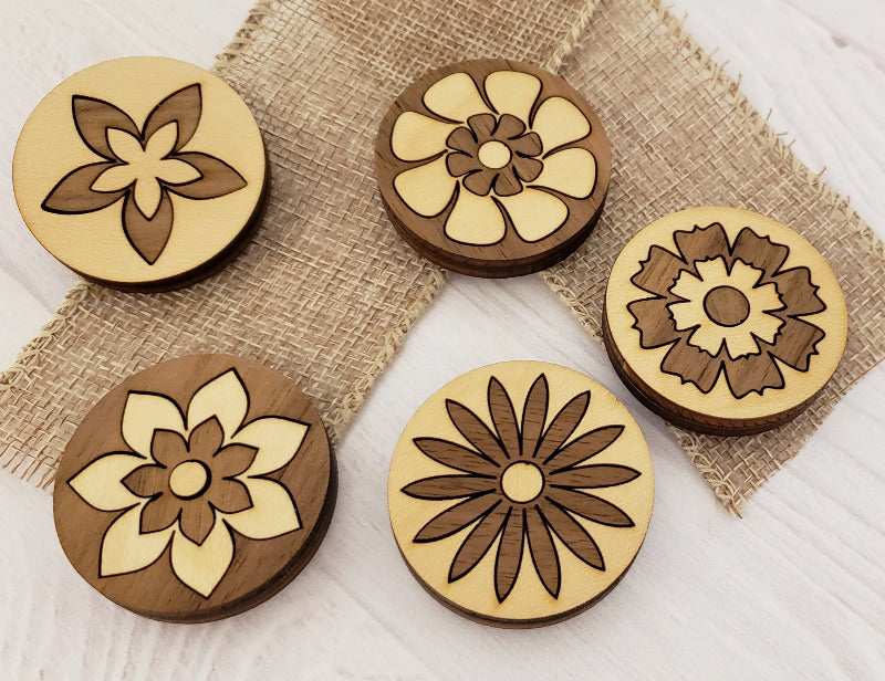 Set of 5 magnets that are two toned wood and display floral designs.