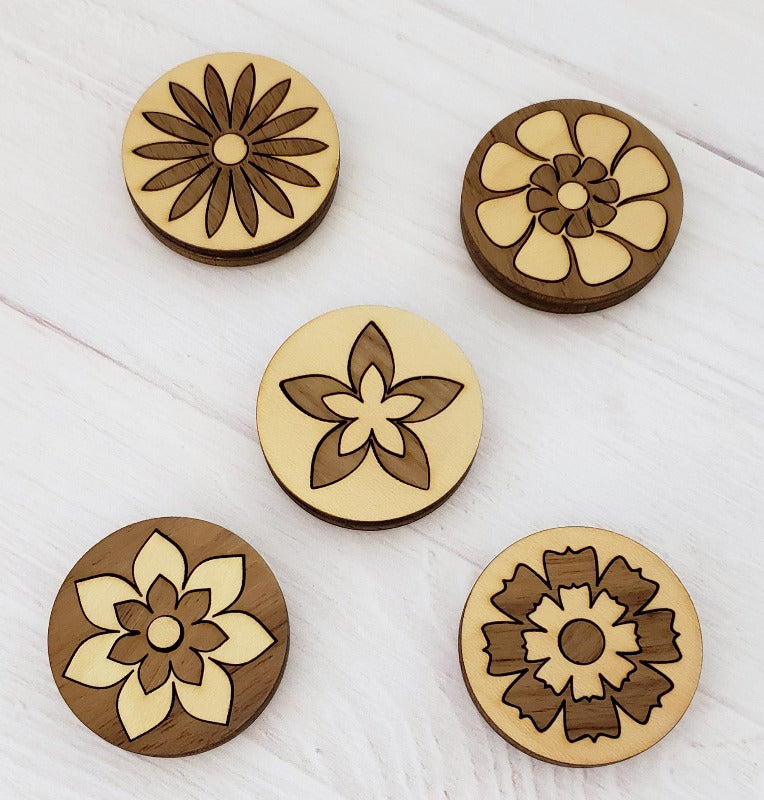 Set of five floral designed magnets in maple and walnut.