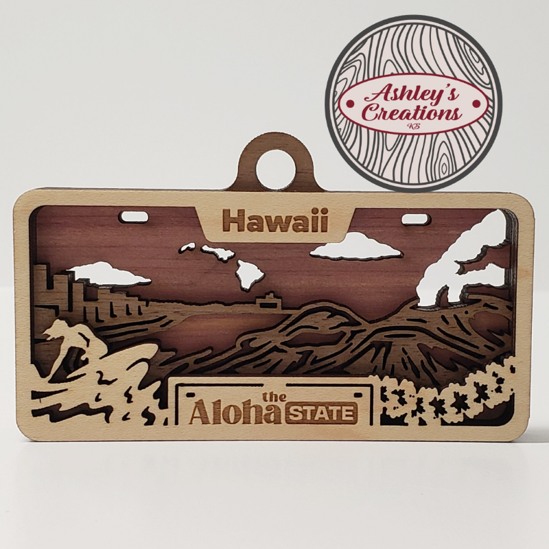 Wooden three layer license plate ornament with Hawaii design and 'Ashley's Creations' logo.