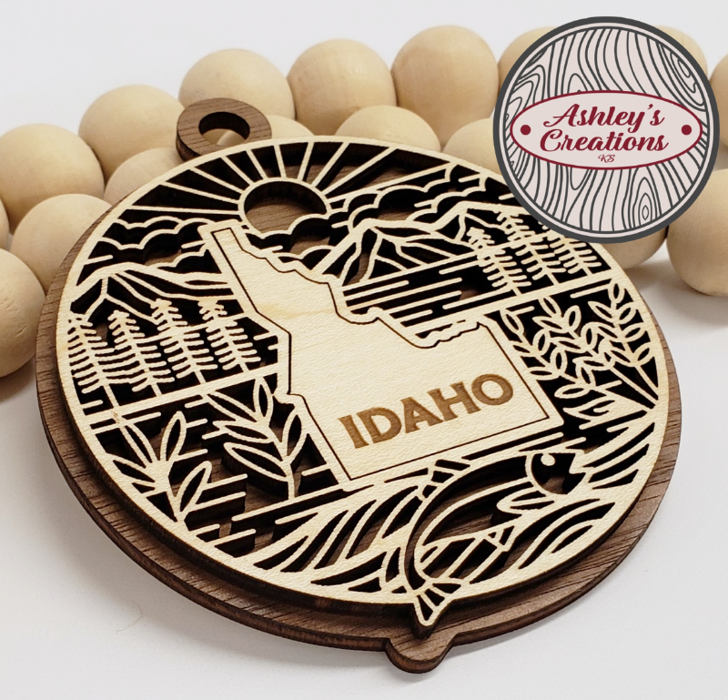 Wooden ornament with 'Idaho' engraving on a white background