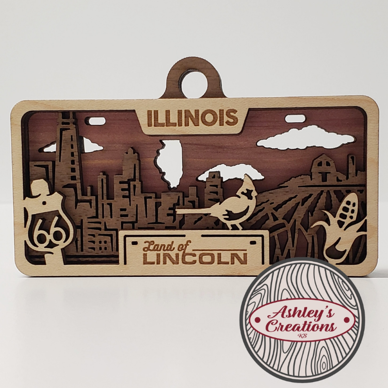 Wooden ornament with Illinois-themed design and 'Ashley's Creations' logo.