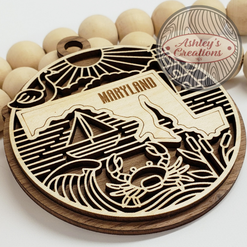 Wooden ornament with the state of Maryland in the middle.