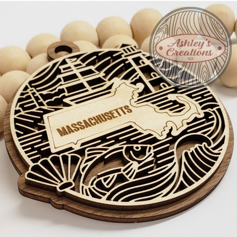 Wooden ornament with the state of Massachusetts in the middle.
