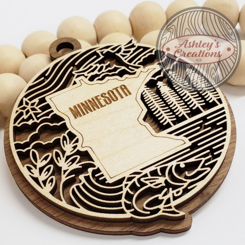 Wooden ornament with the state of Minnesota in the middle.