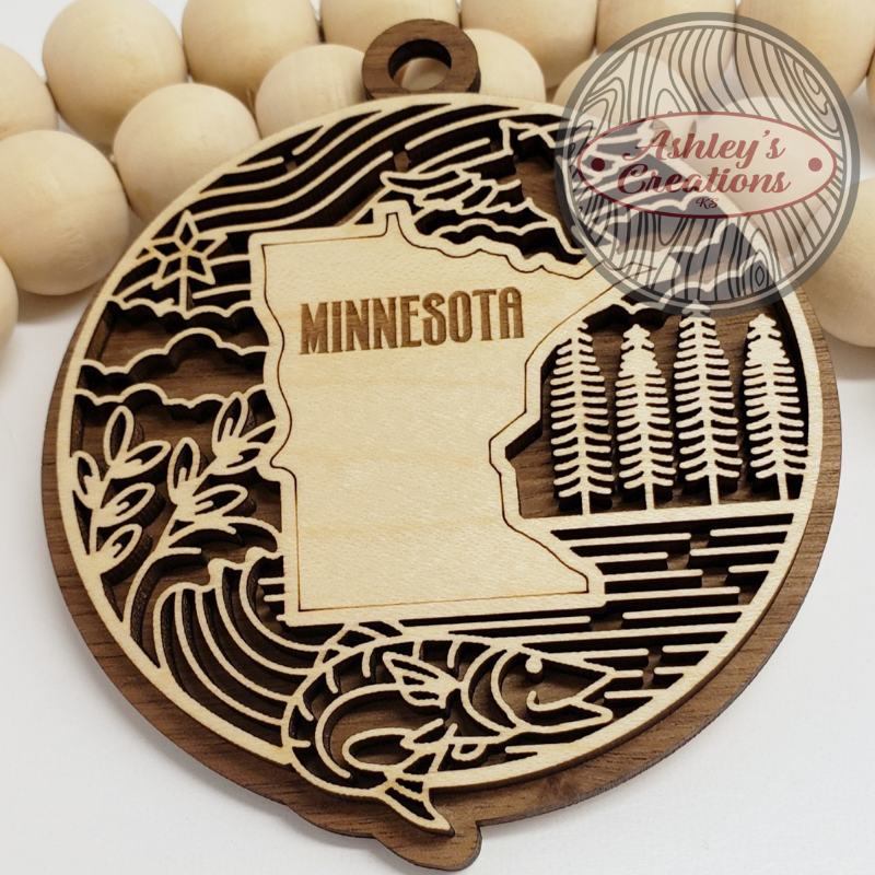 Wooden ornament with the state of Minnesota in the middle.