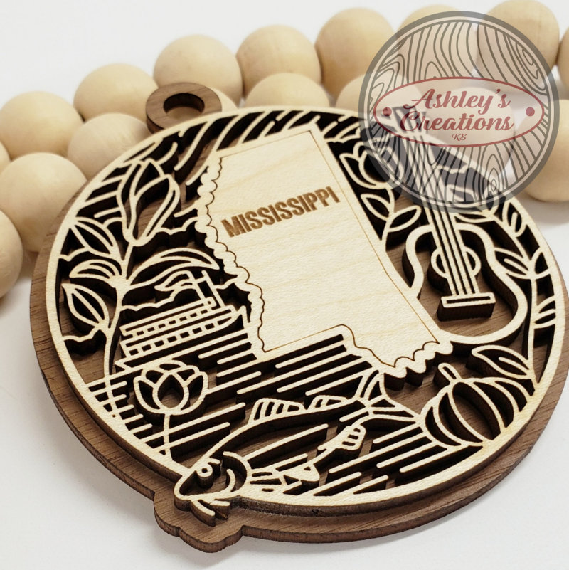 A wooden ornament with the state of Mississippi in the middle.