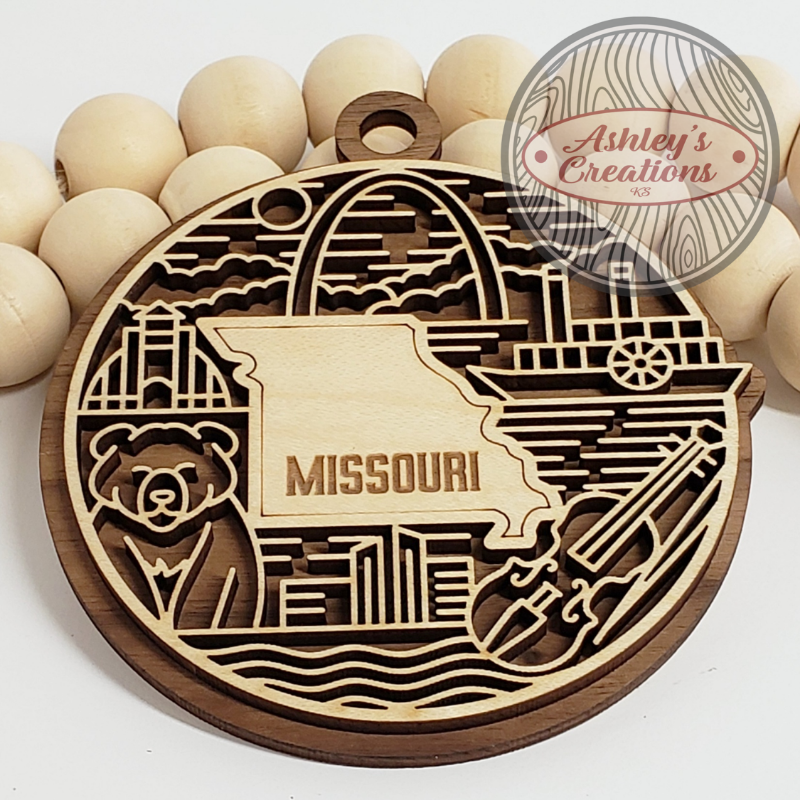 Wooden ornament with the state of Missouri in the middle.