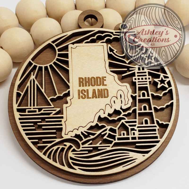Wooden cutout of Rhode Island with lighthouse and sailboat design, branded 'Ashley's Creations'.