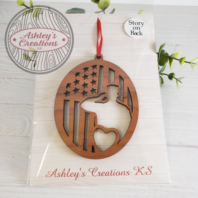 Wooden ornament with American flag design on a branded card, featuring 'Ashley's Creations KS'.