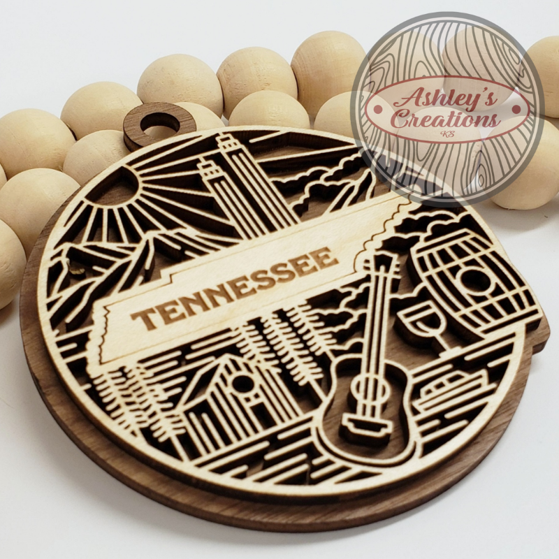 Wooden ornament with Tennessee-themed design and 'Ashley's Creations' branding.