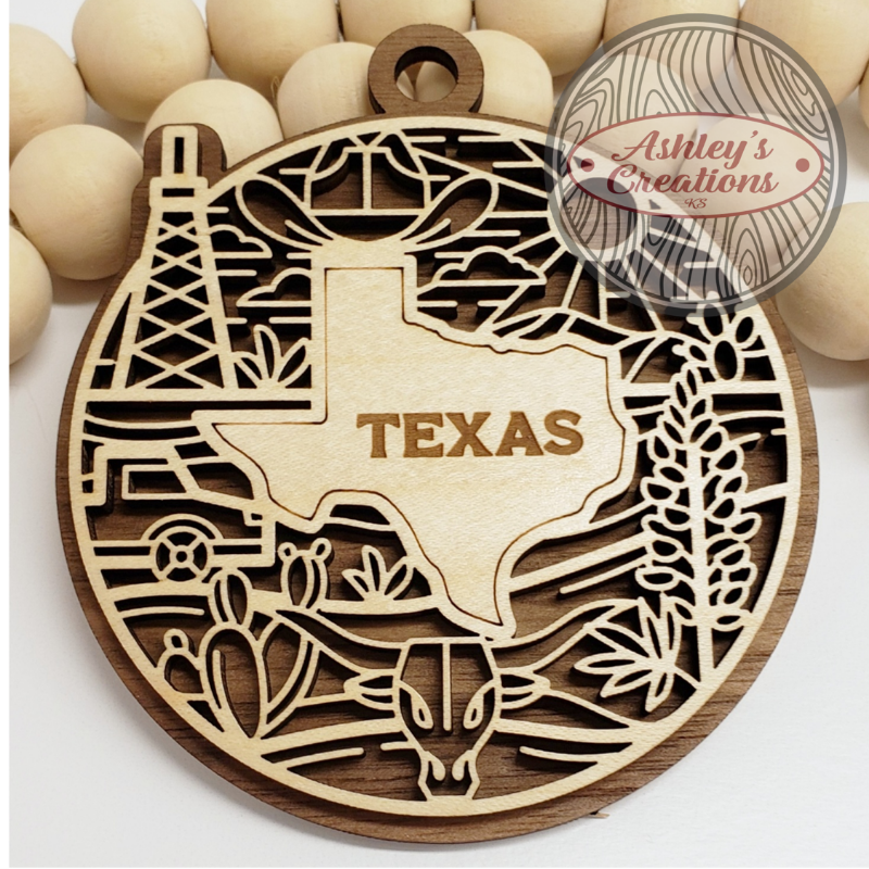 Wooden ornament shaped like Texas with laser cut details on a white background