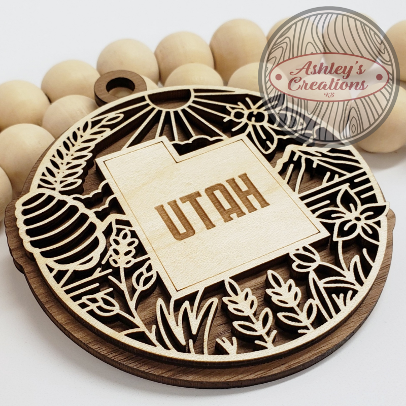 Wooden ornament with 'Utah' engraving on a white background